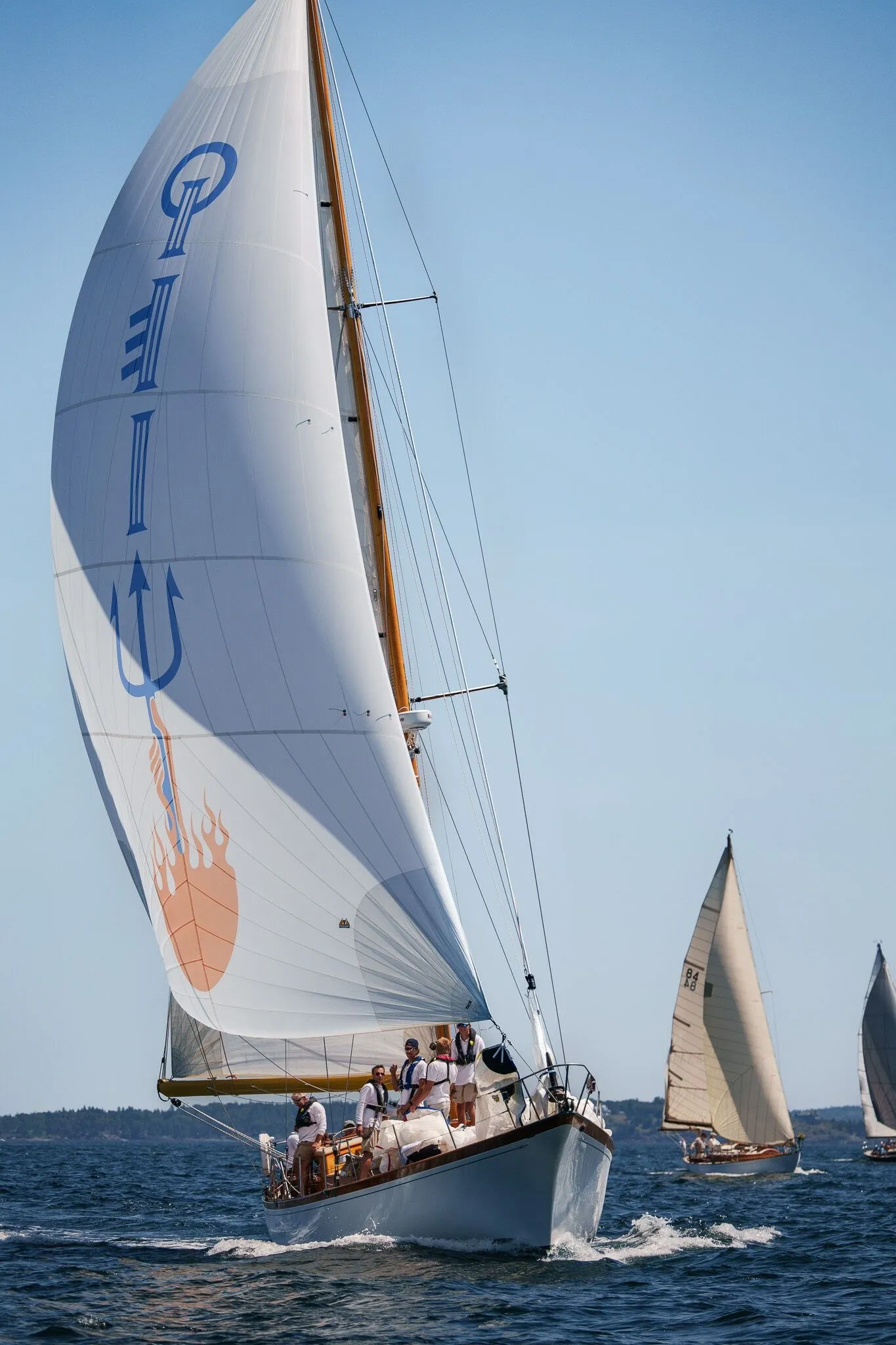 A spinnaker lit against the sky as the fleet runs downwind, Penobscot Bay, ME