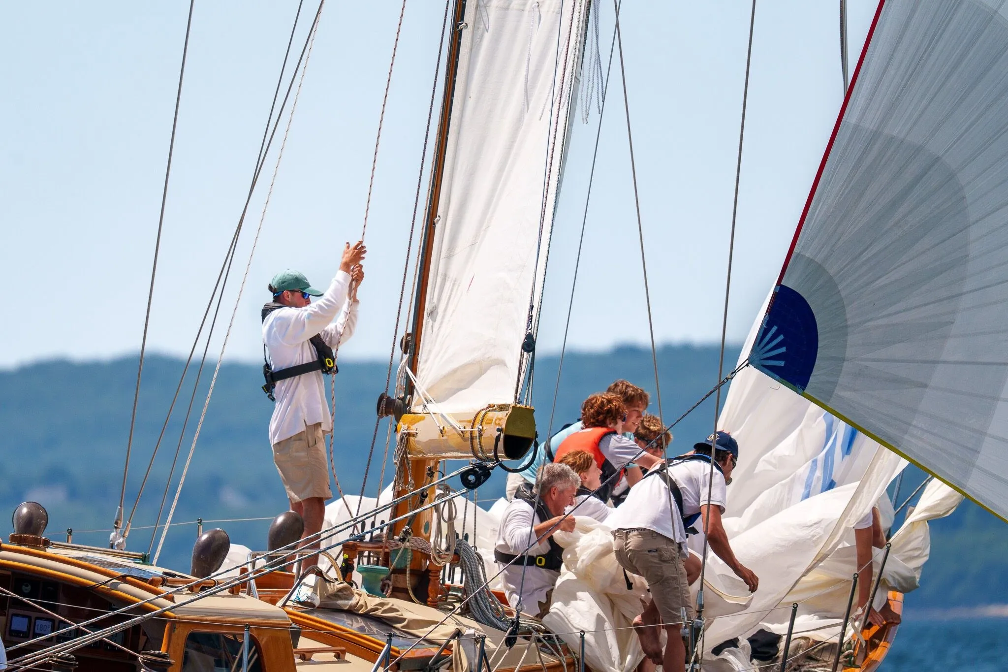 Crew working the foredeck under a full spinnaker, Penobscot Bay, ME